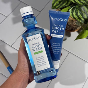 MooGoo Natural Moothwash and MooGoo Natural Moothpaste held side by side, whitening peppermint toothpaste with hydroxyapatite, alcohol-free spearmint mouthwash, natural dental care products