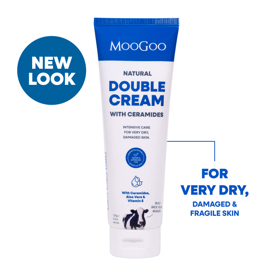 MooGoo Natural Double Cream with Ceramides tube shown on a white background. The product tube is white with blue text and a blue cap band. An intensive moisturiser for very dry and damaged skin with post treatment hydration.