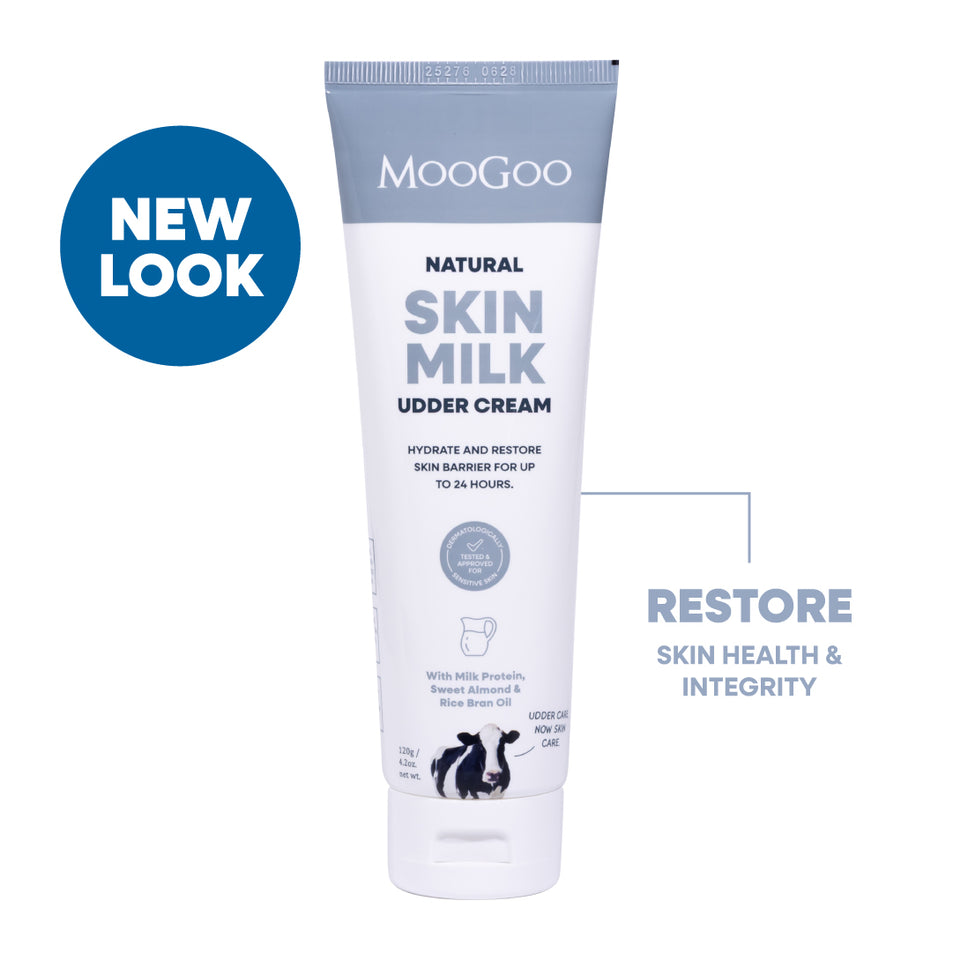 MooGoo Natural Skin Milk Udder Cream tube on a white background with a blue 'NEW LOOK' badge and text. Natural restorative moisturiser with aloe vera and vitamin E for dry, sensitive or damaged skin.